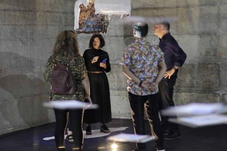 Ambassador Elsa Håstad talking to exhibition curator and others