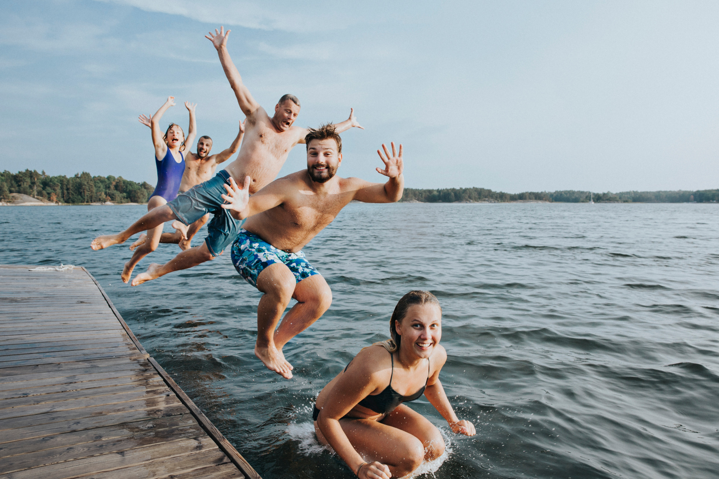 Family jumping in water