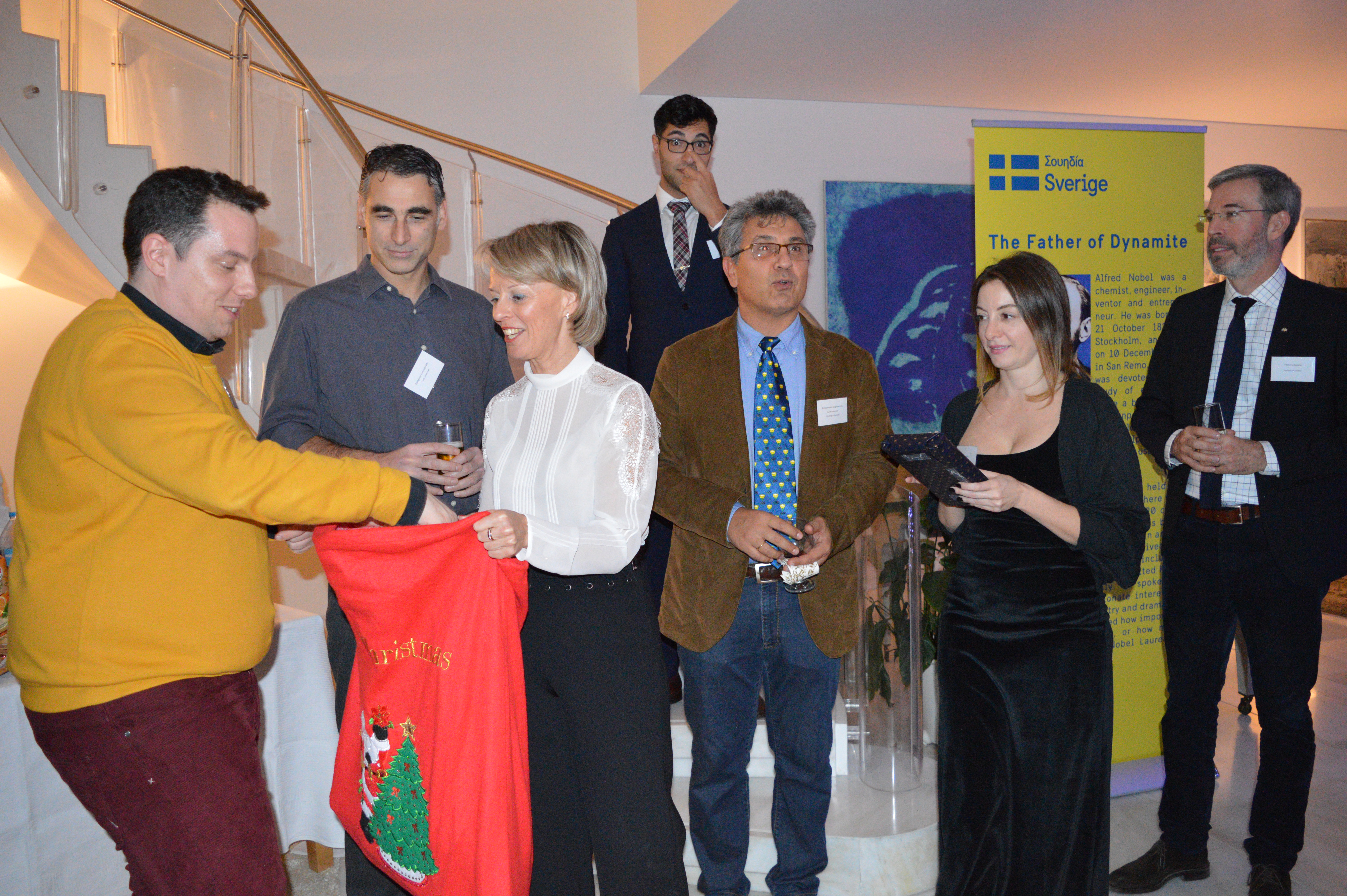 Ambassador Sammelin giving prizes to winners of the quiz.
